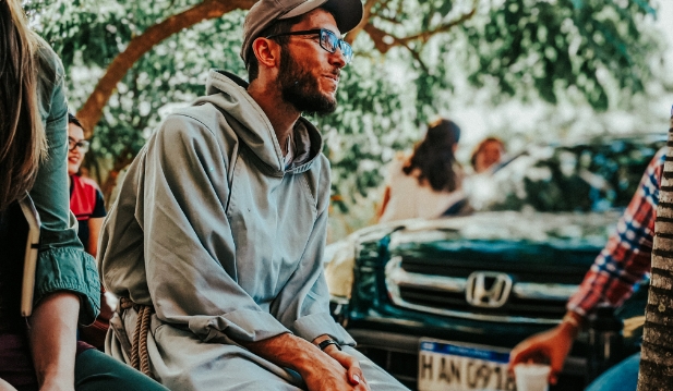 Franciscan Missionary sitting in front of car