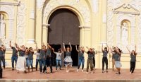 Entire team of missionaries dancing in front of church